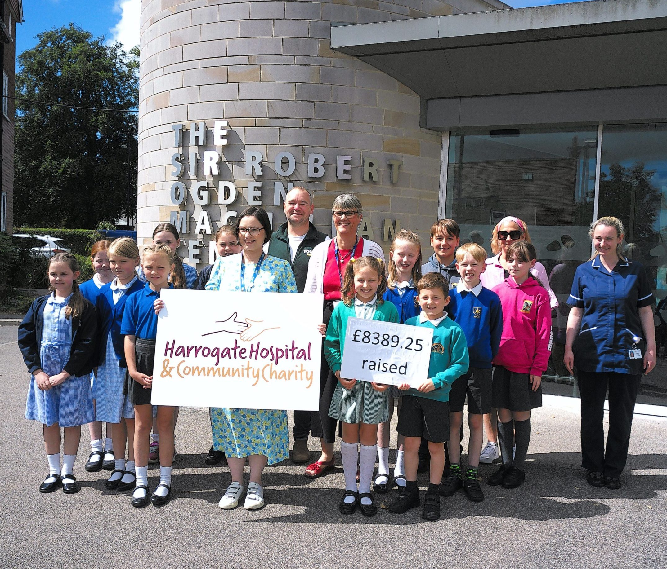 Rural Schools Concert. Children and staff presenting amount raised