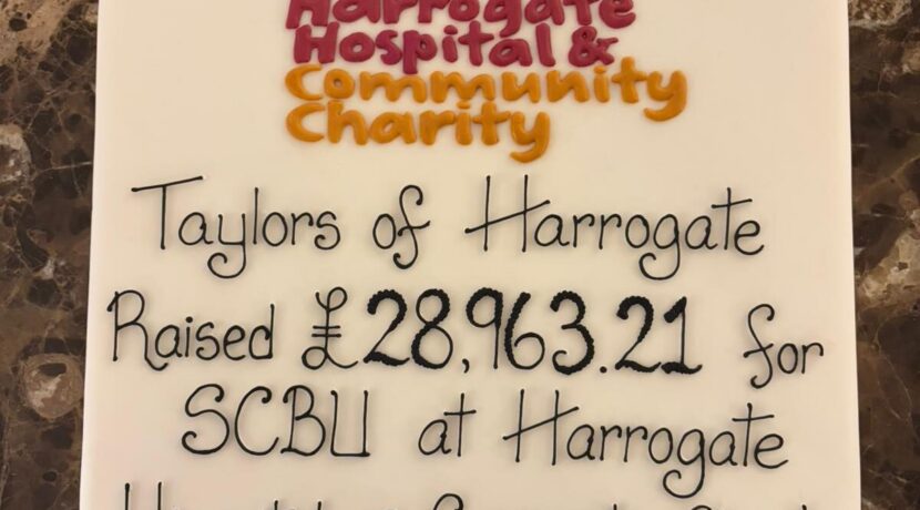 A large white cake with iced text stating 