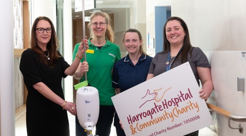 Four women are stood in the corridor with the Airglove equipment