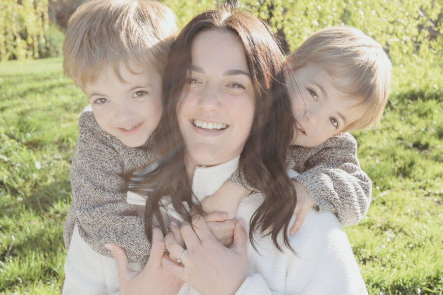 Image of Hannah and two sons in an open grass